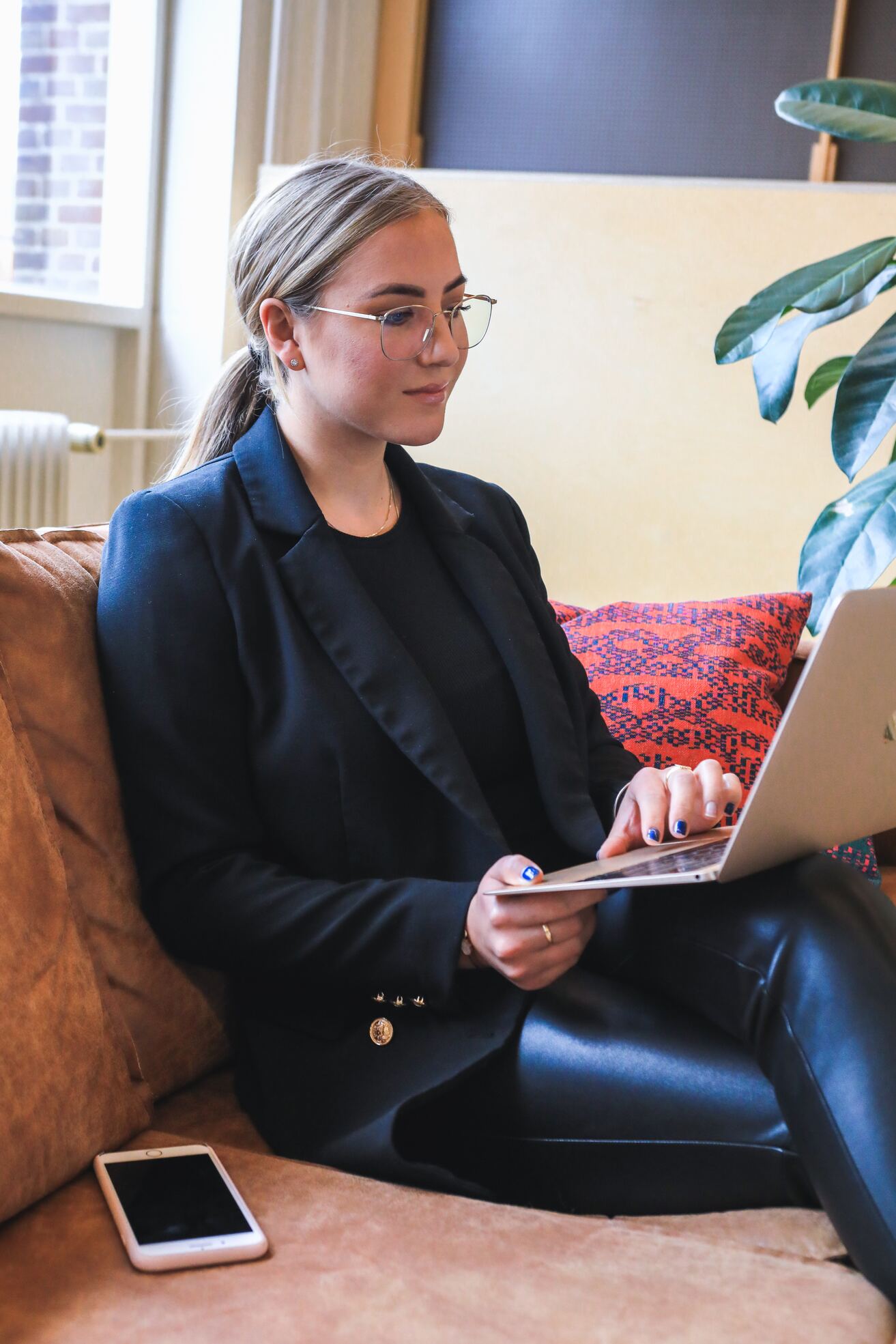 woman in black blazer using macbook
