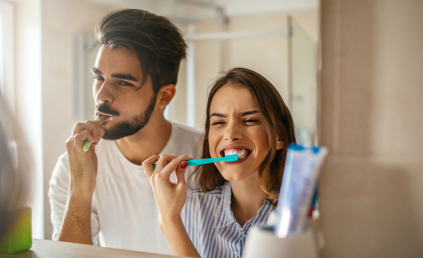 Couple brushing teeth